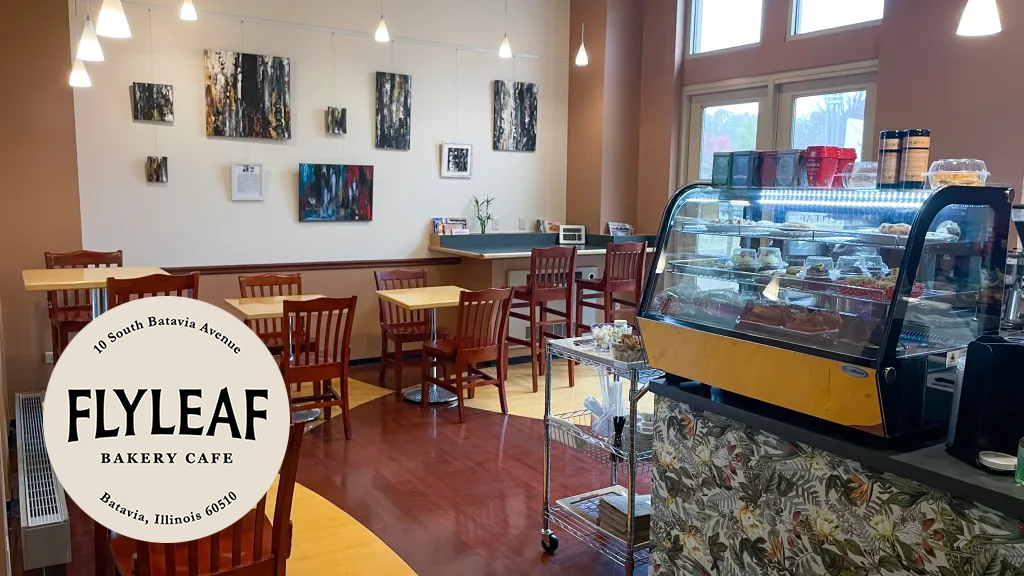 Flyleaf cafe interior with tables, chairs, and dessert case with an overlay of the cafe logo