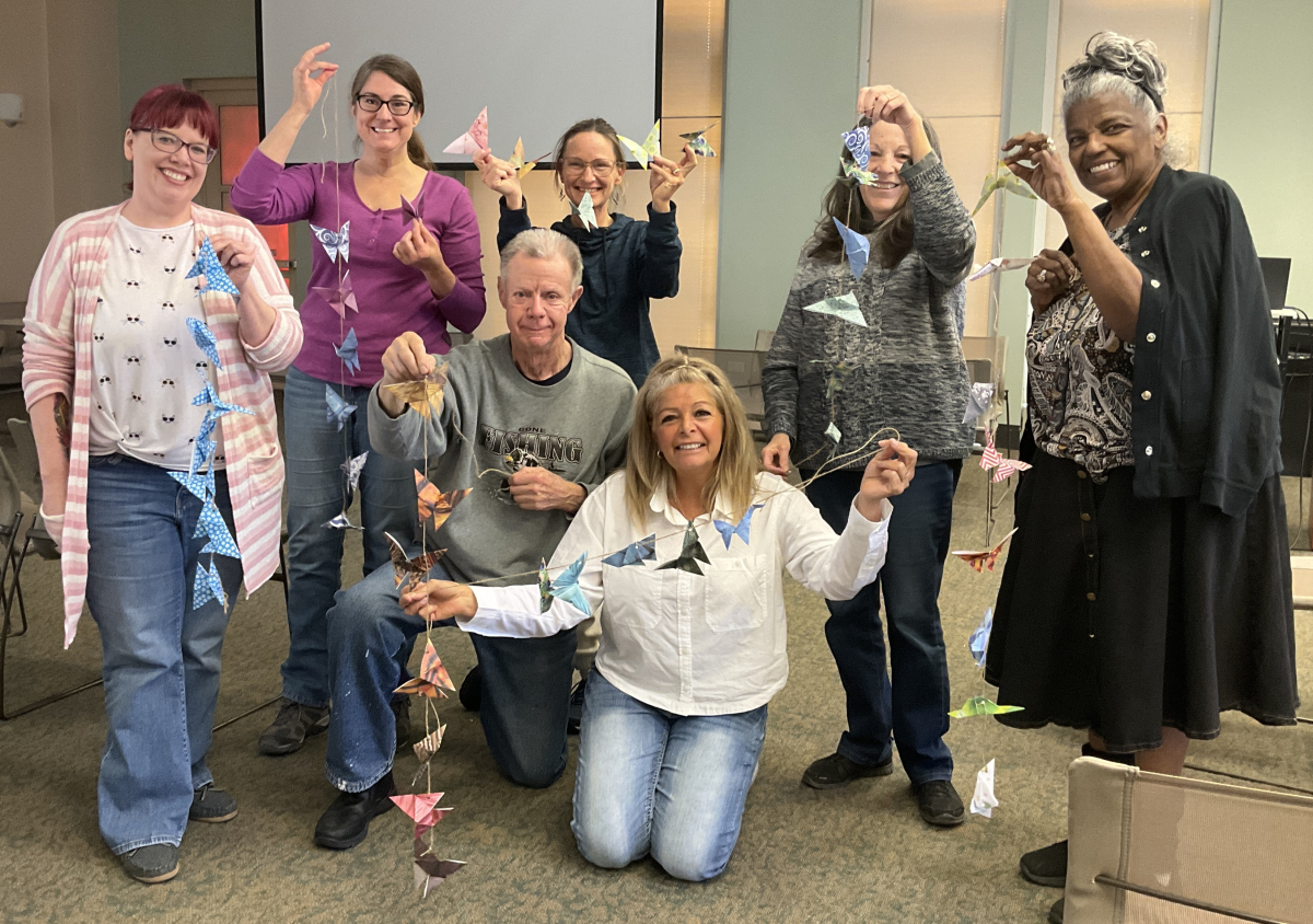 Seniors holding up crafts they made
